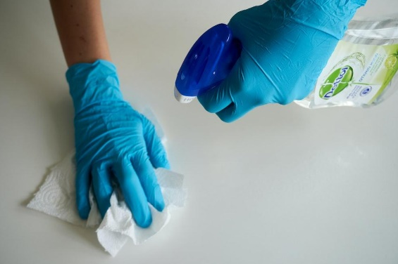 cleaner with gloves cleaning table